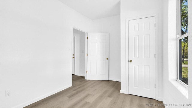 interior space with light wood-type flooring and a closet