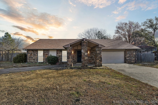 single story home with a lawn and a garage