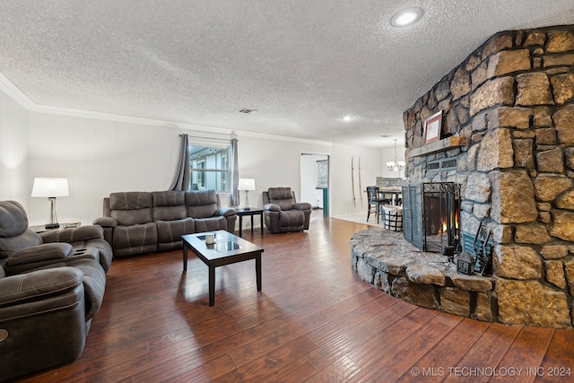 living room featuring a stone fireplace, crown molding, hardwood / wood-style floors, and a textured ceiling