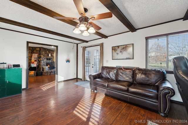 living room featuring french doors, a textured ceiling, ceiling fan, dark wood-type flooring, and beam ceiling