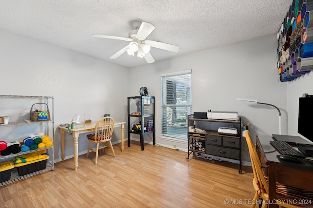 office with ceiling fan, light wood-type flooring, and a textured ceiling