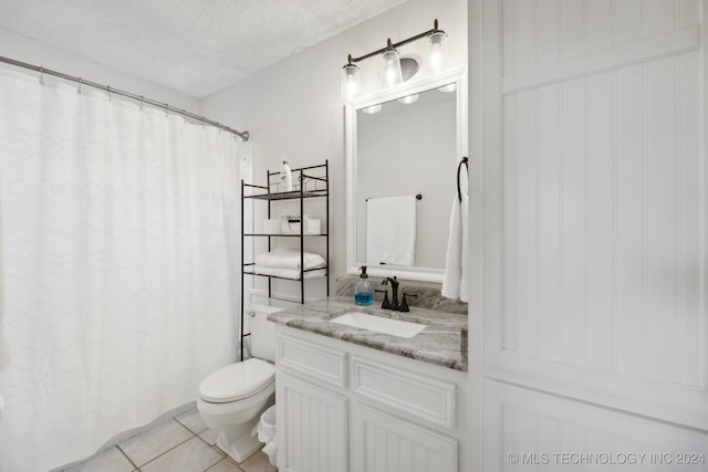 bathroom with tile patterned flooring, a textured ceiling, vanity, and toilet