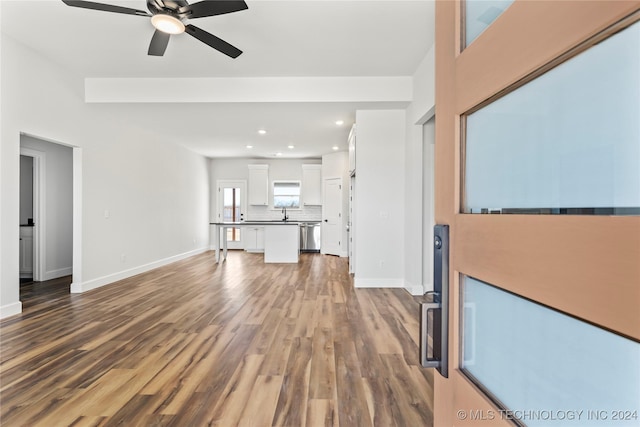 unfurnished living room with ceiling fan and hardwood / wood-style flooring