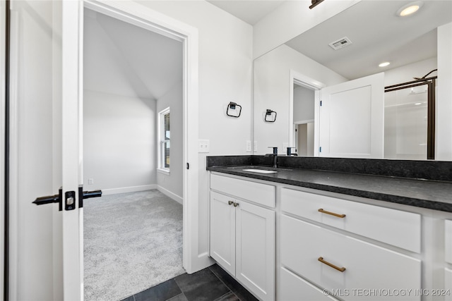 bathroom featuring a shower and vanity