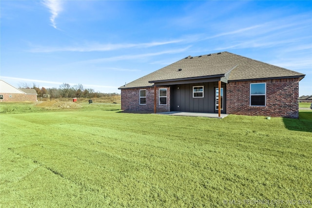 back of house with a lawn and a patio area