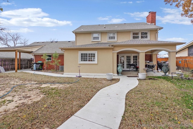 rear view of property with french doors and a patio