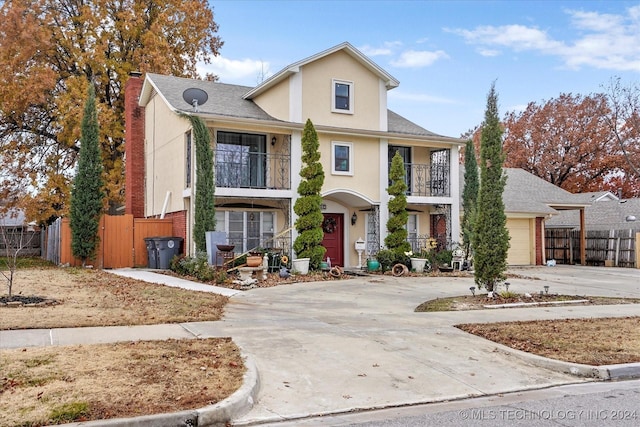 view of property featuring a balcony and a garage