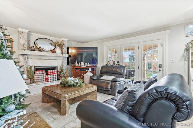 living room featuring light tile patterned flooring, crown molding, a high end fireplace, and french doors