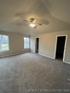 carpeted empty room featuring ceiling fan, a healthy amount of sunlight, and vaulted ceiling