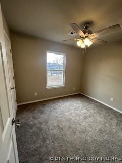 carpeted spare room with ceiling fan