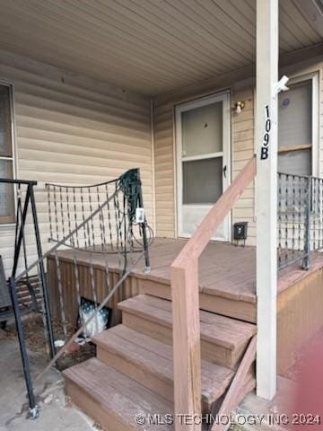 view of exterior entry featuring a porch