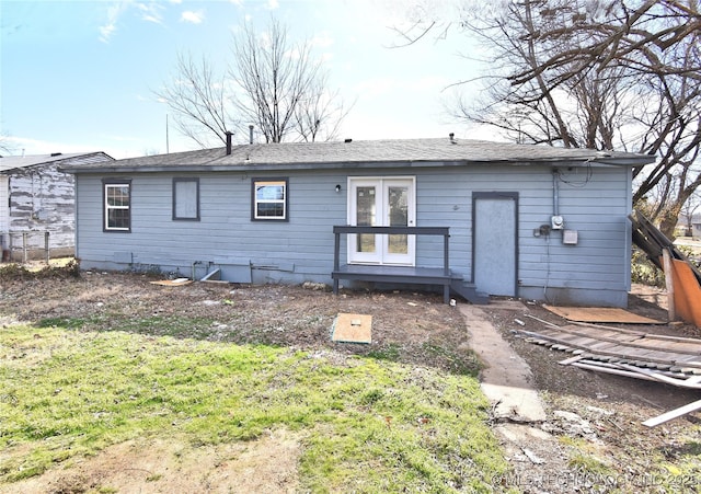 rear view of property with a lawn