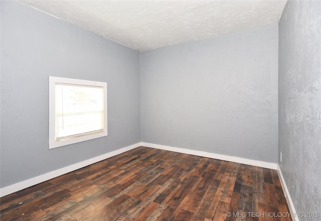 unfurnished room featuring dark hardwood / wood-style flooring