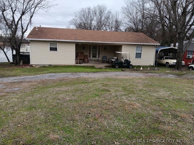 rear view of house featuring a lawn and a patio area