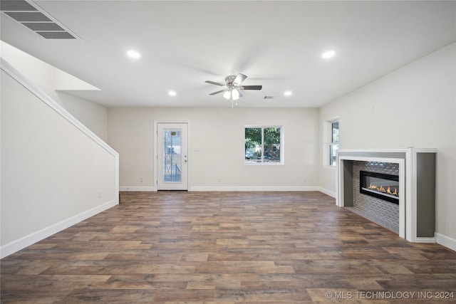 unfurnished living room with ceiling fan and dark wood-type flooring