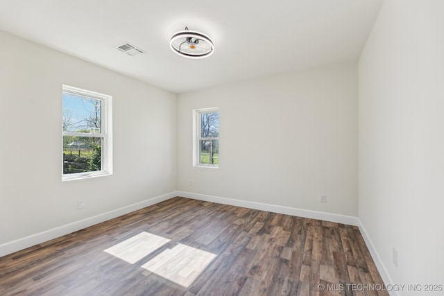 1006 N K St, Muskogee, OK 74403 - spare room featuring healthy amount of natural light and wood finished floors