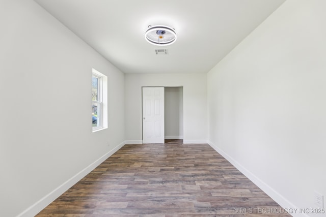 1006 N K St, Muskogee, OK 74403 - spare room featuring wood finished floors and baseboards