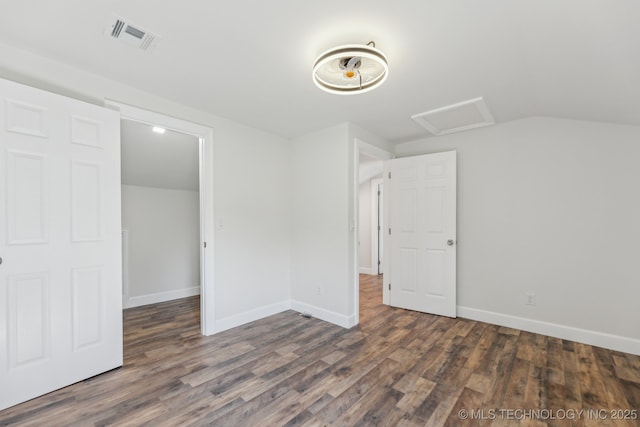 1006 N K St, Muskogee, OK 74403 - unfurnished bedroom featuring wood finished floors, attic access, and vaulted ceiling