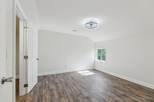 1006 N K St, Muskogee, OK 74403 - spare room with vaulted ceiling and dark wood-style flooring