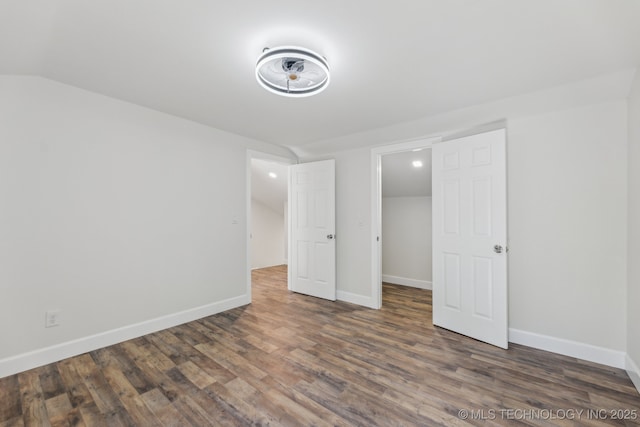 1006 N K St, Muskogee, OK 74403 - unfurnished bedroom with wood finished floors and vaulted ceiling