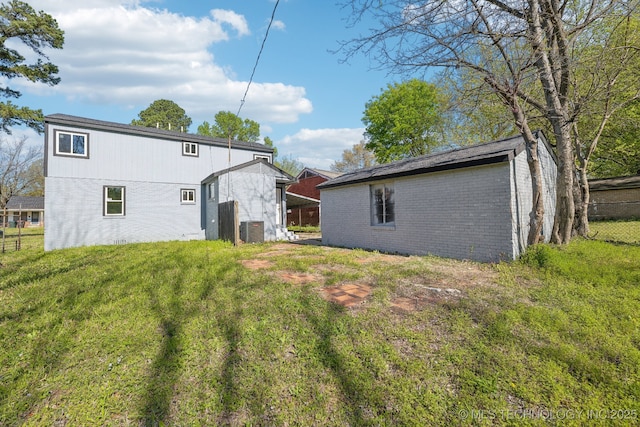 1006 N K St, Muskogee, OK 74403 - rear view of house featuring brick siding and an outbuilding