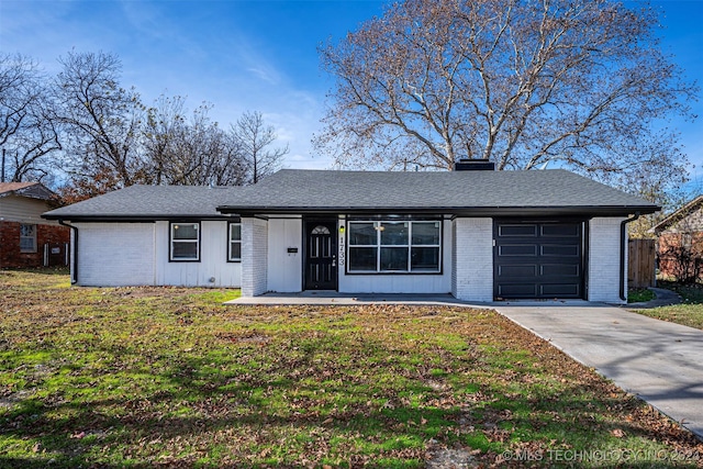 ranch-style house featuring a garage and a front yard