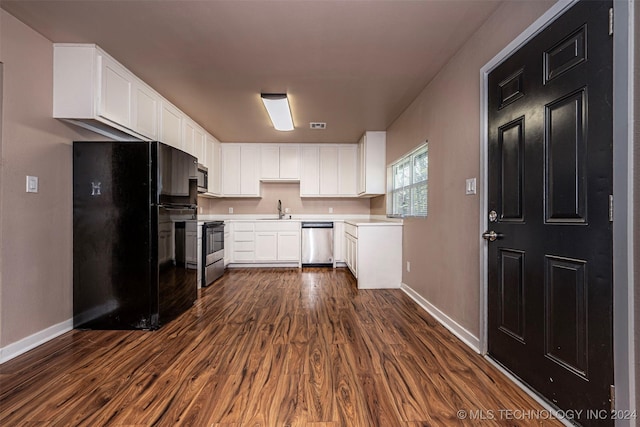 kitchen featuring white cabinets, dark hardwood / wood-style flooring, sink, and stainless steel appliances