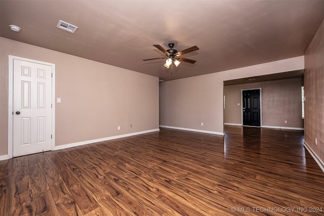 empty room featuring ceiling fan and dark wood-type flooring