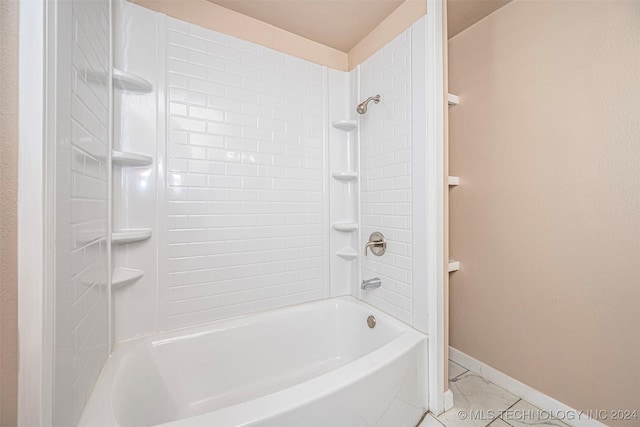 bathroom with tile patterned floors and tiled shower / bath combo