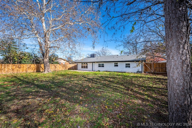 rear view of house with a yard