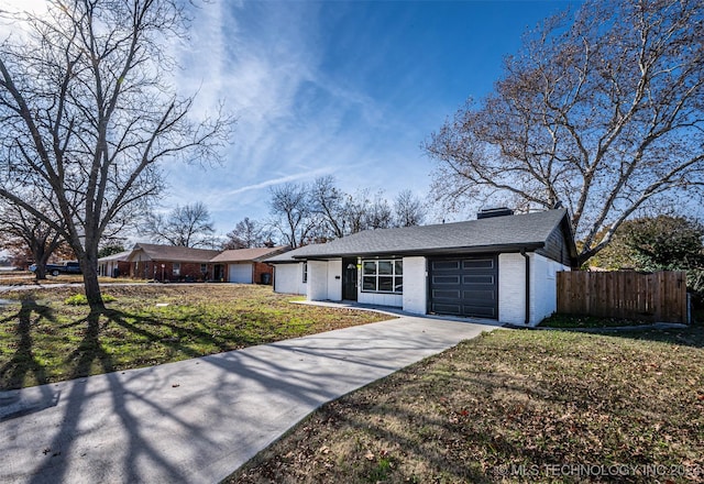 ranch-style home with a garage and a front lawn