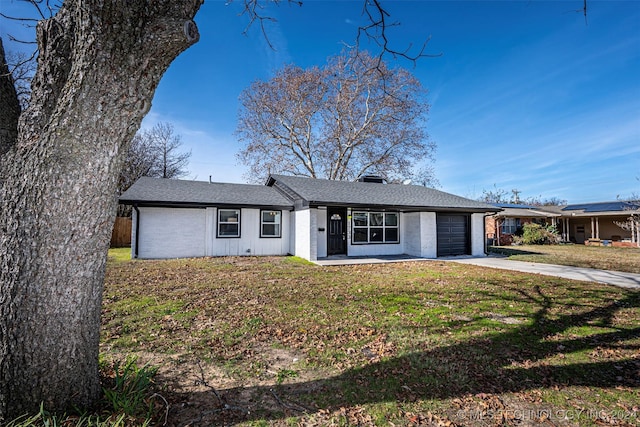 single story home with a front yard and a garage