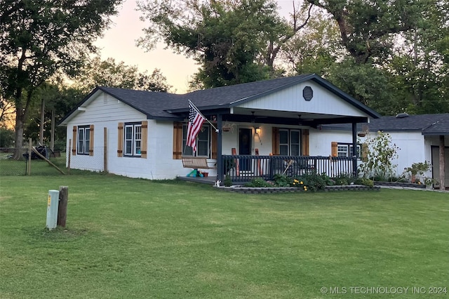 view of front facade with a lawn and a porch