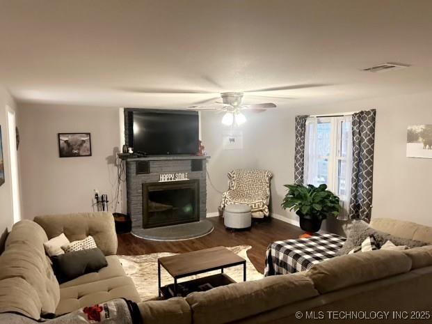 living room with hardwood / wood-style flooring and ceiling fan