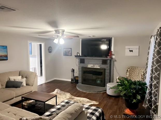 living room featuring ceiling fan and dark hardwood / wood-style flooring