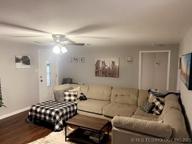 living room featuring hardwood / wood-style flooring and ceiling fan