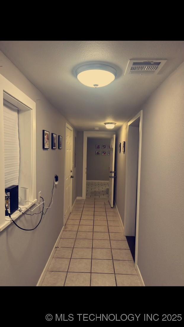 corridor featuring light tile patterned flooring