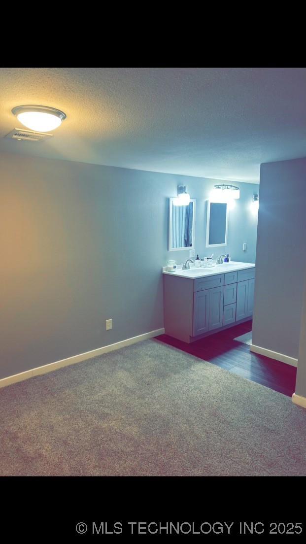 bathroom with vanity and a textured ceiling