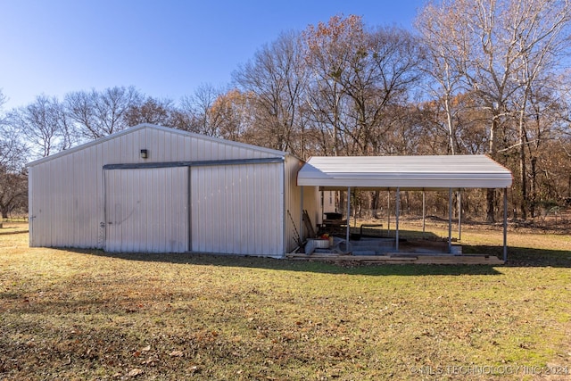 view of outdoor structure with a lawn and a carport