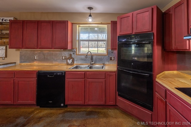 kitchen featuring wood counters, backsplash, sink, black appliances, and hanging light fixtures