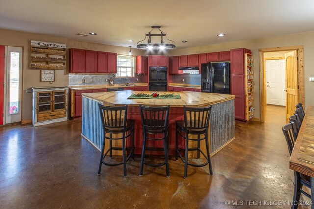 kitchen featuring sink, butcher block countertops, tasteful backsplash, and black appliances