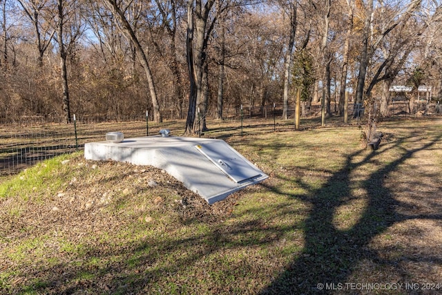 view of storm shelter featuring a yard