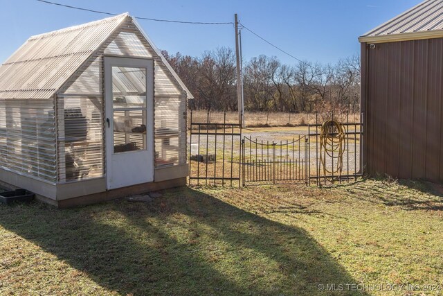 view of outdoor structure featuring a lawn