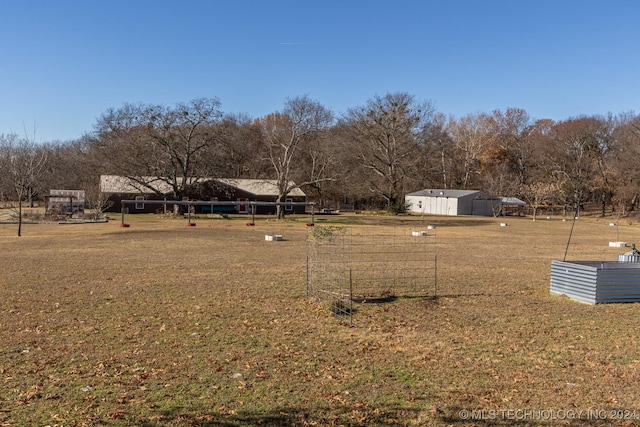 view of yard featuring an outdoor structure and a rural view