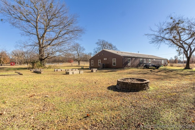 view of yard with a wooden deck and a fire pit