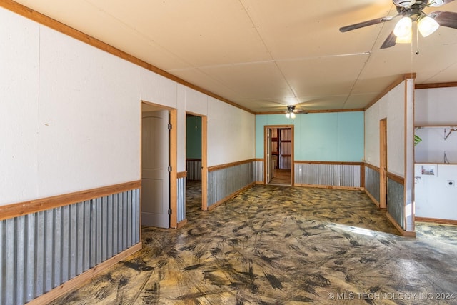 empty room featuring ornamental molding and ceiling fan