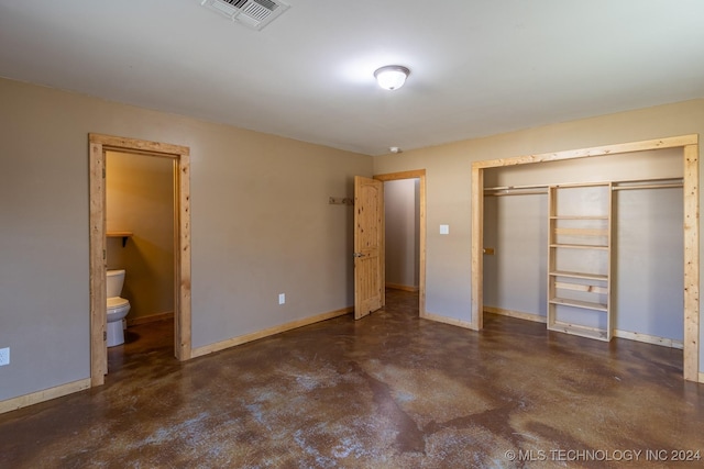 unfurnished bedroom with ensuite bathroom and a closet