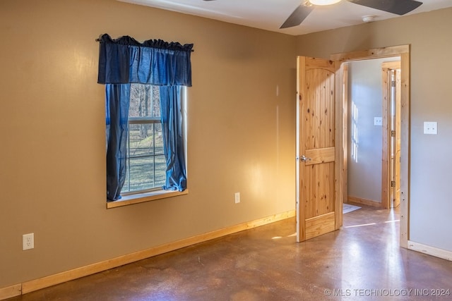 unfurnished bedroom featuring ceiling fan and concrete floors