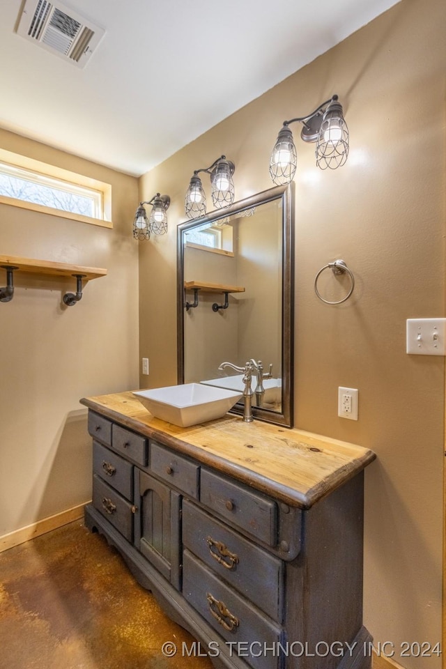 bathroom with vanity and concrete floors