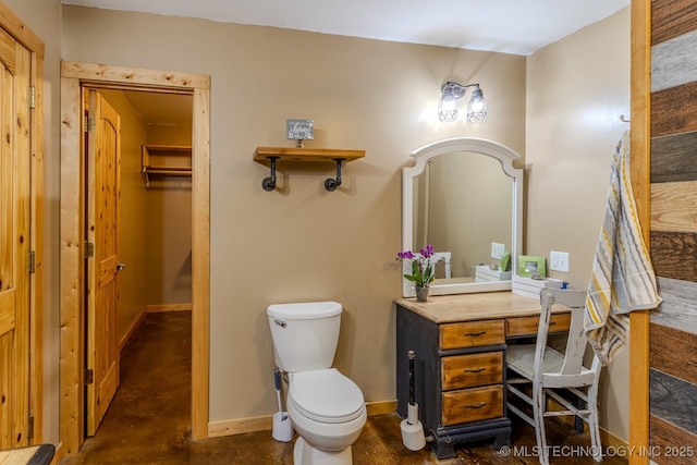 bathroom with concrete floors and toilet